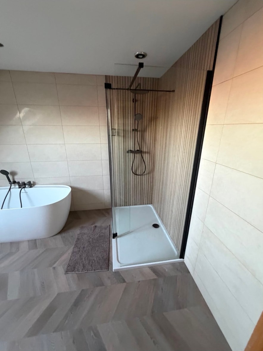 Bathroom with a walk-in shower enclosure alongside a freestanding bath