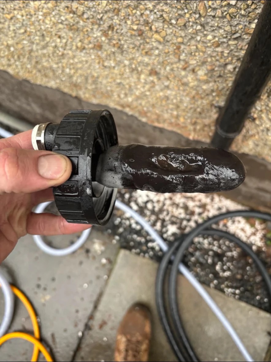 Black magnetite sludge removed from a central heating system during powerflushing